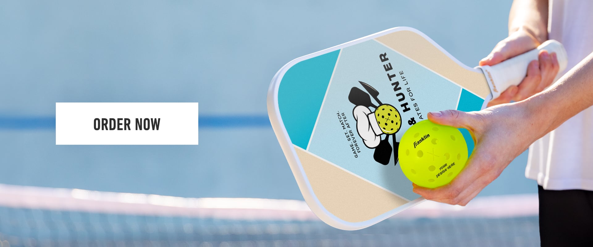 pickleball player on a court holding a franklin custom pickleball paddle and pickleball