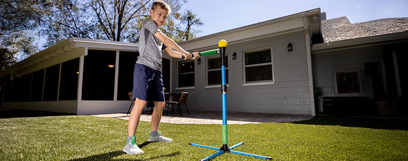 child swinging plastic baseball bat