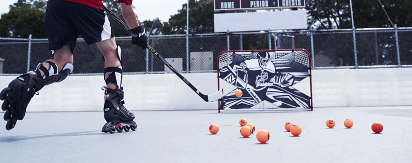 street hockey balls and player shooting at net