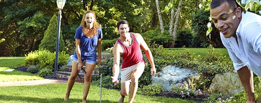 adults playing horseshoes